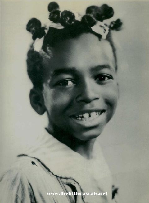 1993 Ford Bronco - A young child smiles, showing a gap in their teeth, with hair styled in buns and decorated with bows.