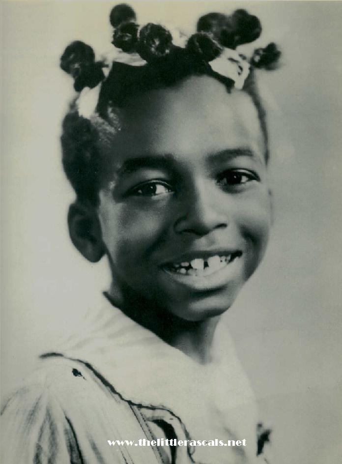 Child with hair styled in buns and bows