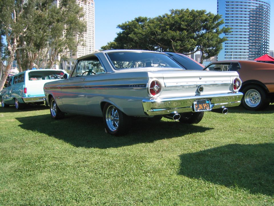 Silver 1965 Ford Falcon coupe rear view with custom wheels and chrome bumper