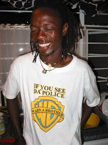 1991 Ford Bronco - A man smiles while wearing a t-shirt the Warner Bros. logo and the phrase "WARN A BROTHER".