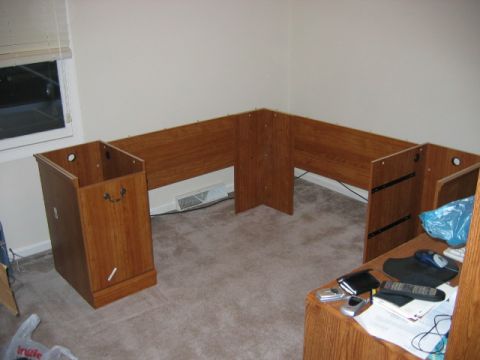 1985 Ford LTD Crown Victoria - A corner desk unit and a wooden filing cabinet are set up in a room.