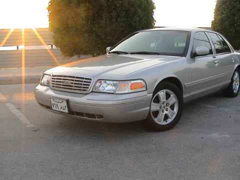 2004 Ford Crown Victoria - This sedan has a distinctive grille and headlight design, consistent with a 2004 model year.