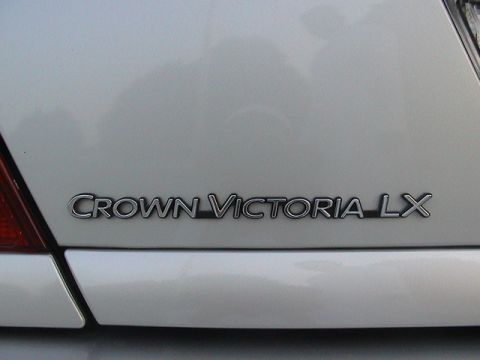2004 Ford Crown Victoria - Close-up of the Crown Victoria LX badge on the rear of a vehicle.