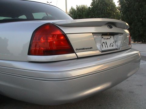 2004 Ford Crown Victoria - The rear of a silver Ford Crown Victoria is shown with a spoiler and a license plate.