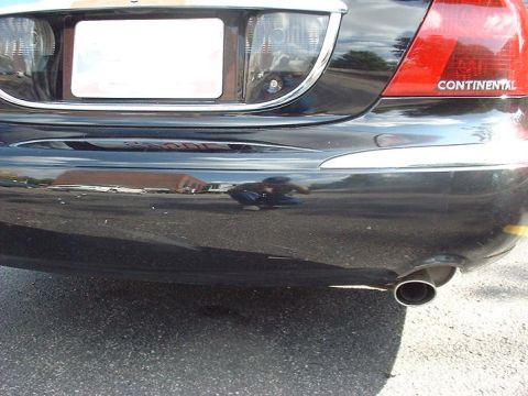 1997 Ford Crown Victoria - Close-up of a car's rear bumper and taillight, with 'CONTINENTAL' visible on the lens.