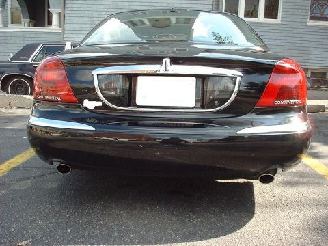 1997 Ford Crown Victoria - Rear view of a black Lincoln Continental parked in a lot, with another car visible behind it.