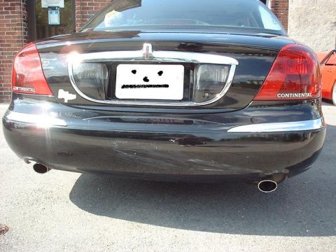 1997 Ford Crown Victoria - Black Lincoln Continental's rear end, showing taillights and bumper.