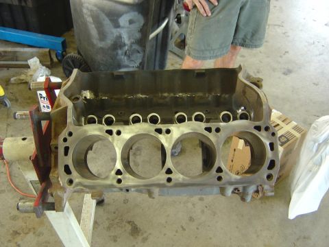 1993 Ford Bronco - Engine block on a stand, with visible cylinder bores and internal engine parts.