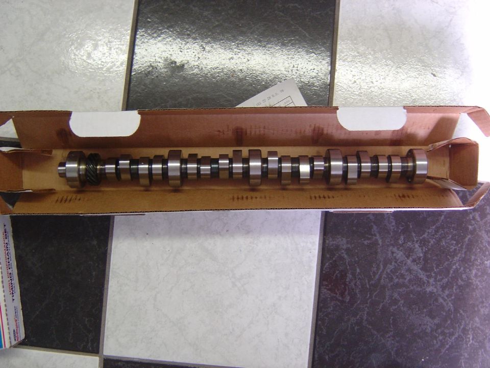 Camshaft in a cardboard box, with a gear on one end
