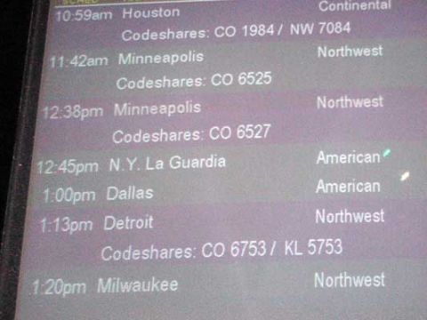 1995 Ford Bronco - A digital display shows flight schedules with departure times, destinations, and airline codeshares.