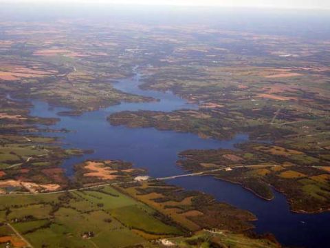 1995 Ford Bronco - An aerial perspective captures a winding lake surrounded by patchwork fields and a bridge crossing the water.