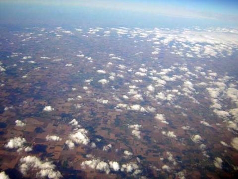 1995 Ford Bronco - An aerial perspective reveals a patchwork of farmland dotted with fluffy white clouds.