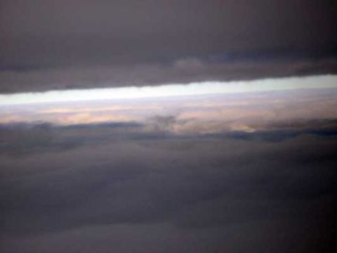 1995 Ford Bronco - View from an airplane window shows layers of clouds at different altitudes.