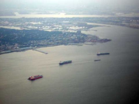 1995 Ford Bronco - Several ships are visible on the water near a coastal city.