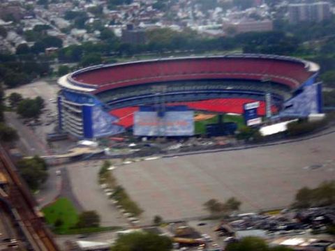 1995 Ford Bronco - An aerial perspective captures a vast stadium complex, highlighting its distinctive red seating and blue exterior features.