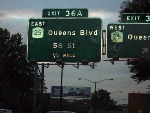 1995 Ford Bronco - Overhead highway signs indicate an upcoming exit for Queens Boulevard and 58th Street.
