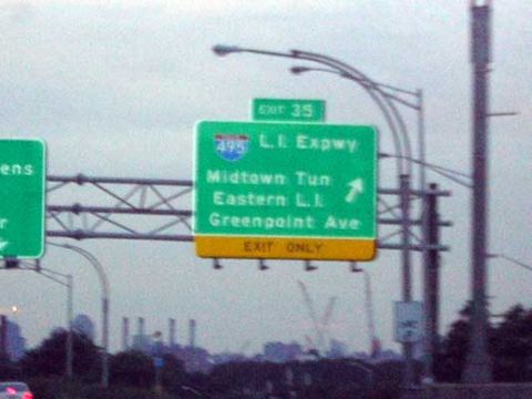 1995 Ford Bronco - Green highway exit sign indicating directions to L.I. Expwy, Midtown Tunnel, Eastern L.I., and Greenpoint Ave.