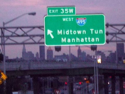1995 Ford Bronco - Highway signs point towards Midtown Tunnel and Manhattan, with a city skyline visible.