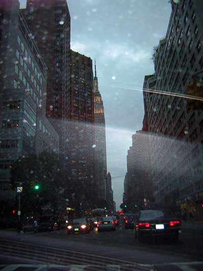 1995 Ford Bronco - Traffic moves through New York City streets on a cloudy day, with the Empire State Building visible in the distance.