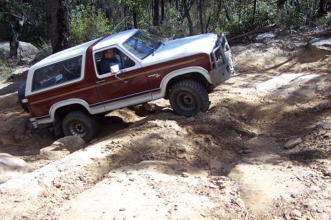 1982 Ford Bronco - Ford Bronco tackling challenging terrain on an off-road trail.