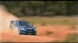 1990 Ford Bronco - A blue rally car speeds along a dirt track, creating a cloud of dust.