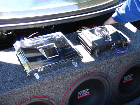 1996 Ford Taurus - Two car audio amplifiers and subwoofers are installed in the trunk of a vehicle.