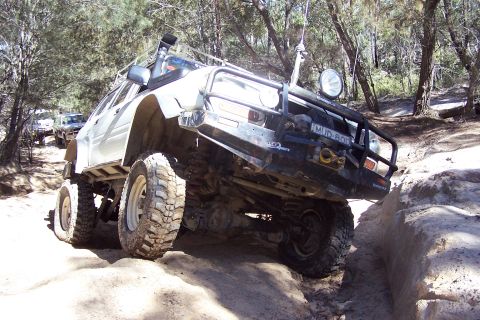1982 Ford Bronco - This vehicle is navigating a challenging off-road course with other vehicles visible in the background.