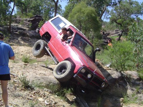 1982 Ford Bronco - This 1982 Ford Bronco is navigating a challenging off-road course on a sunny day.