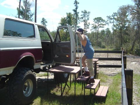 1993 Ford Bronco - Person with crutches uses portable steps to get into a 1993 Ford Bronco.