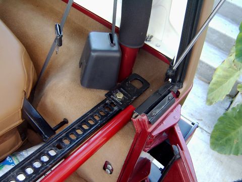 1998 Jeep TJ - Hi-Lift jack stowed inside a vehicle's interior.