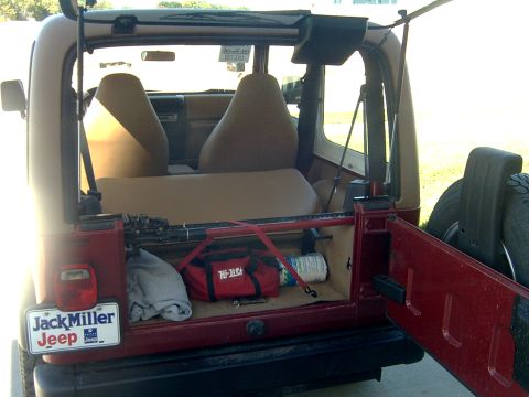 1998 Jeep TJ - Rear view of a red Jeep TJ showing its cargo space and interior.