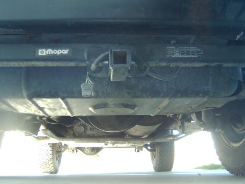 1998 Jeep TJ - Underside view reveals a hitch receiver and Mopar branding on the vehicle's undercarriage.