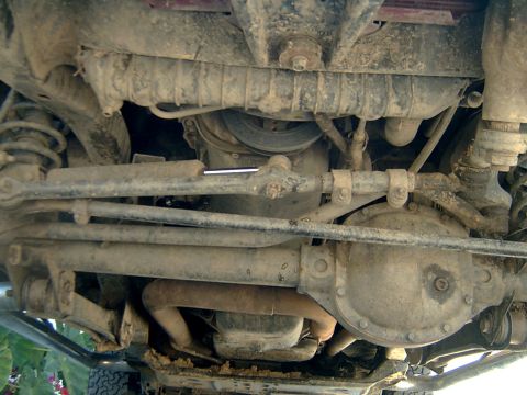 1998 Jeep TJ - Underside view of a 1998 Jeep TJ, showing the front axle and steering components.