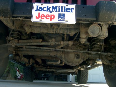 1998 Jeep TJ - The underside of a Jeep shows its suspension and drivetrain components.