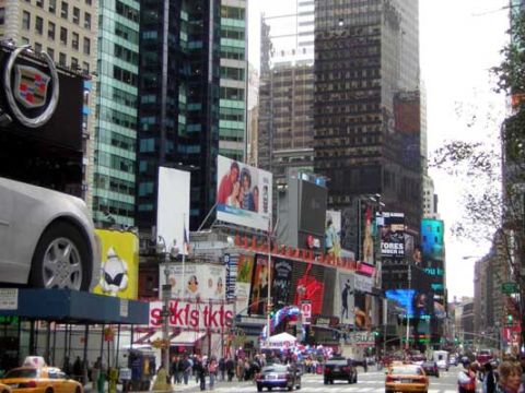 1995 Ford Bronco - Busy street scene in Times Square with many digital billboards and yellow taxis.