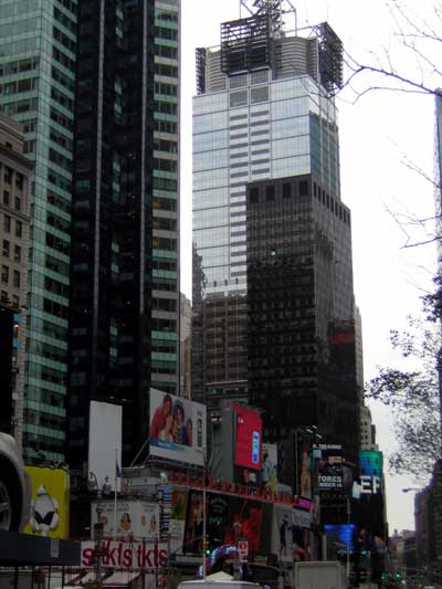 1995 Ford Bronco - A view of Times Square with its iconic billboards and towering skyscrapers under an overcast sky.