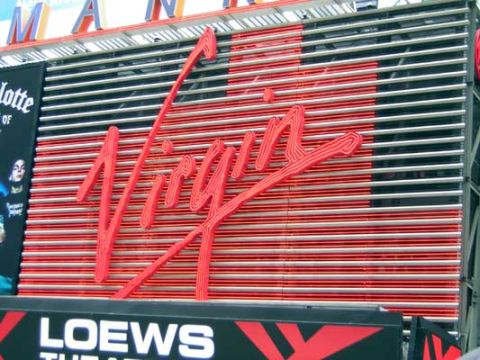 1995 Ford Bronco - Virgin logo displayed prominently on a building facade with horizontal striped background.