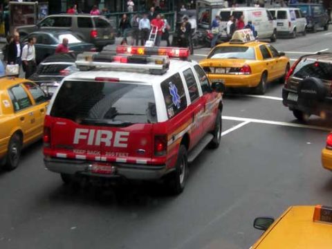 1995 Ford Bronco - An emergency response vehicle with 'FIRE' markings is seen in traffic alongside yellow taxis and other vehicles.