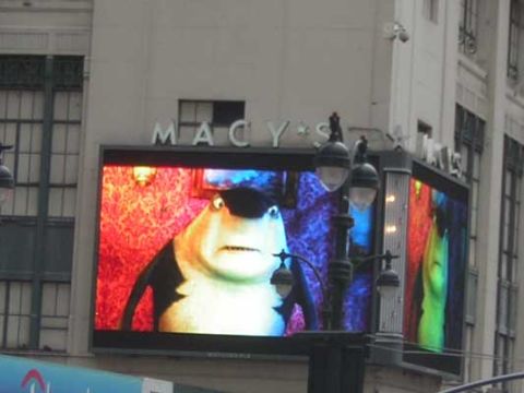 1995 Ford Bronco - A digital billboard displays an animated shark character with a colorful, patterned background.