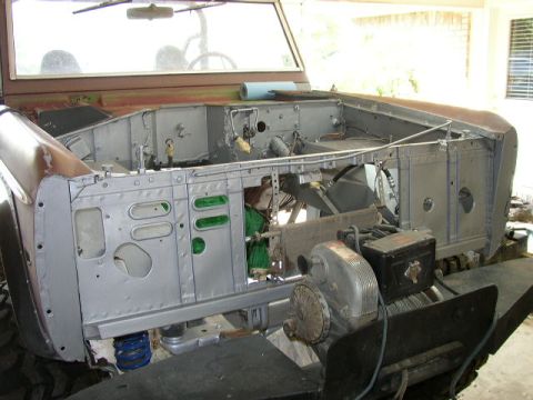 1995 Ford Bronco - This vehicle's engine bay is exposed, showing internal components and a winch, indicating it is undergoing maintenance.