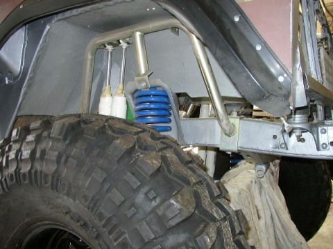 1995 Ford Bronco - Custom suspension components visible on an off-road vehicle, including a blue coil spring.