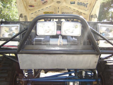 1991 Ford Bronco - Front view of a 1991 Ford Bronco with a winch and brush guard, hood is open.