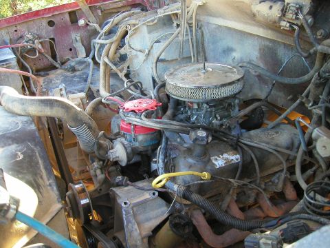 1989 Ford Bronco - Close-up of a Ford V8 engine bay with various components visible.