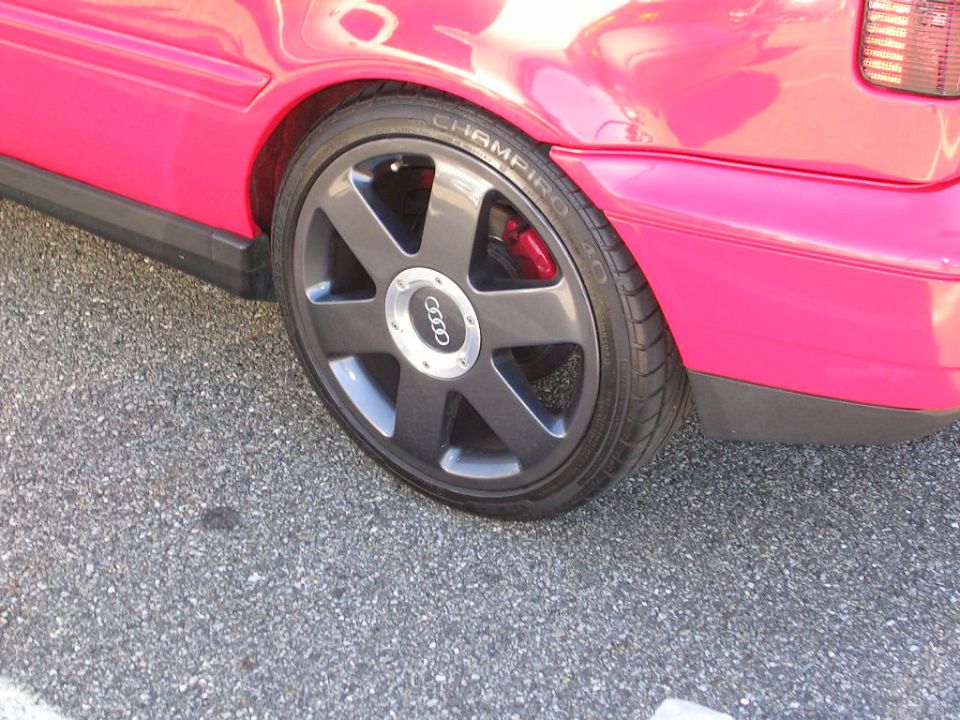 Pink Audi with multi-spoke wheels and red brake calipers