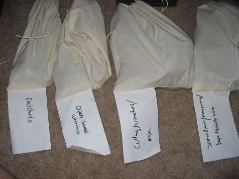 1988 Ford Bronco - Four cloth bags containing tools are neatly labeled for easy identification and storage.