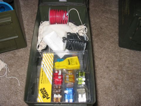 1988 Ford Bronco - An ammo can is repurposed to store a variety of automotive fuses and electrical wire, including red and black spools.