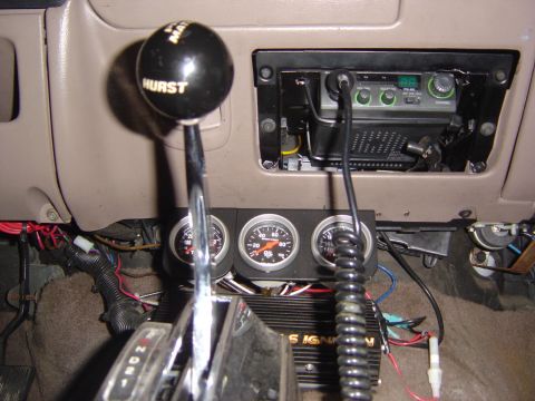 1993 Ford Bronco - Interior view of a 1993 Ford Bronco, aftermarket gauges and a CB radio.