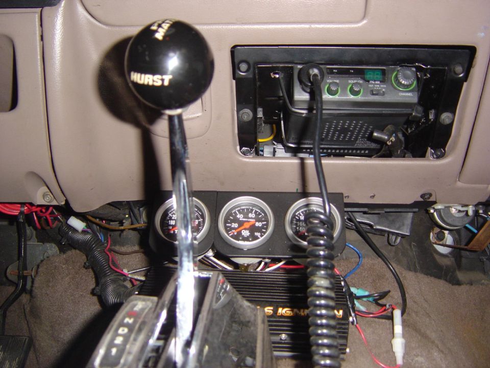 1993 Ford Bronco interior showing Hurst shifter, three gauges, and CB radio