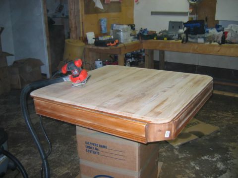 1985 Ford LTD Crown Victoria - Workshop scene with a sander working on a wooden tabletop.