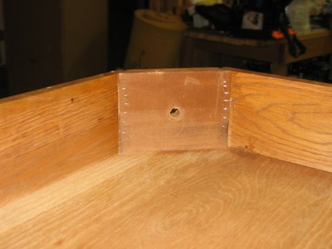 1985 Ford LTD Crown Victoria - Close-up view of the inside of a wooden drawer, showing construction details and a central hole.